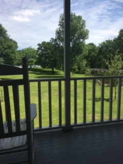 A picture containing outdoor, building, man, green

Description automatically generated